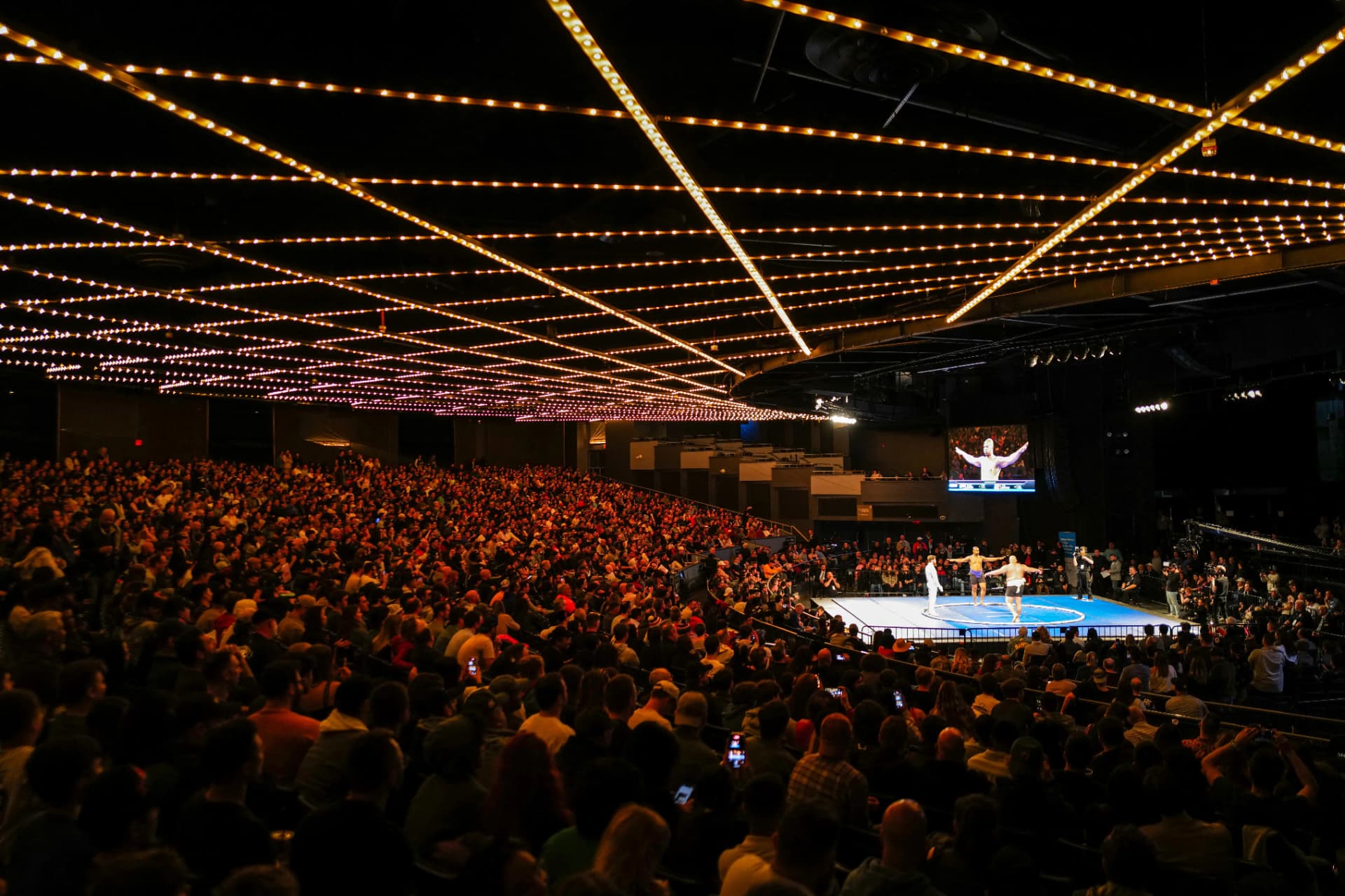 Packed arena crowd watching a World Championship Sumo bout